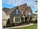 Two-story home with stone and shingle accents, attached garage, and manicured lawn at 6022 Candlestick Ln, Lancaster, SC 29720