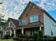 Two story home with stone and shingle accents, welcoming porch, and landscaped lawn at 6022 Candlestick Ln, Lancaster, SC 29720