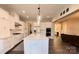 Modern kitchen with white cabinets, large island, and stainless steel appliances at 6022 Candlestick Ln, Lancaster, SC 29720