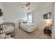 Charming bedroom with a crib and double bed, carpeted floors at 6142 Cloverdale Dr, Tega Cay, SC 29708