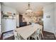 Bright dining room features a farmhouse table and chandelier, adjacent to the kitchen at 6142 Cloverdale Dr, Tega Cay, SC 29708