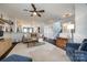 Open living room with neutral color palette and view of kitchen at 6142 Cloverdale Dr, Tega Cay, SC 29708