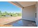 Covered back porch overlooking a large backyard and rural landscape at 6324 Honor Ave, Midland, NC 28107