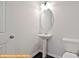 Small, updated powder room with pedestal sink and oval mirror at 6324 Honor Ave, Midland, NC 28107