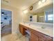 Double vanity bathroom with a large mirror and plenty of counter space at 6608 Brookgreen Ter, Matthews, NC 28104