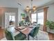 Dining room with a live edge table and green velvet chairs at 6608 Brookgreen Ter, Matthews, NC 28104