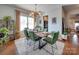 Dining room with a live edge table and green velvet chairs at 6608 Brookgreen Ter, Matthews, NC 28104