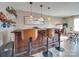 Home bar with wooden barstools and pendant lighting at 6608 Brookgreen Ter, Matthews, NC 28104