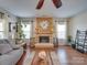 Living room features a wood-paneled fireplace and hardwood floors at 6608 Brookgreen Ter, Matthews, NC 28104