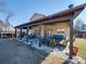 Covered patio with seating and dining area, surrounded by landscaping at 6608 Brookgreen Ter, Matthews, NC 28104