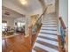 Modern staircase with wooden railing and white risers at 6608 Brookgreen Ter, Matthews, NC 28104