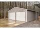 Spacious two-car detached garage with white roll-up doors at 6751 Lackey Rd, Vale, NC 28168