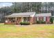 Brick ranch house with covered porch and landscaped yard at 6751 Lackey Rd, Vale, NC 28168