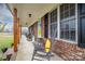 Brick front porch with rocking chairs and sunflowers at 6751 Lackey Rd, Vale, NC 28168