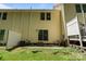The back exterior of the home showcases a small patio surrounded by a lawn, offering a cozy outdoor living space at 7019 Walnut Ridge Ct, Charlotte, NC 28217