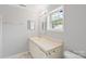 Bathroom featuring a neutral vanity with mirror and an abundance of natural light at 7019 Walnut Ridge Ct, Charlotte, NC 28217