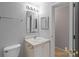 Well-lit bathroom with a large mirror and vanity area, showcasing a functional and clean space at 7019 Walnut Ridge Ct, Charlotte, NC 28217