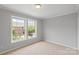 Inviting bedroom with carpet and two large windows, offering natural light and a view at 7019 Walnut Ridge Ct, Charlotte, NC 28217