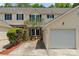 Inviting townhome featuring a well-kept lawn and attached one car garage at 7019 Walnut Ridge Ct, Charlotte, NC 28217