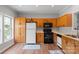 Bright kitchen with wood cabinets and laminate floors at 7019 Walnut Ridge Ct, Charlotte, NC 28217