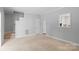 Open-concept living area featuring neutral tones, plush carpeting, and an abundance of natural light at 7019 Walnut Ridge Ct, Charlotte, NC 28217
