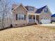 Brick home with a two-car garage and partially visible porch at 721 Red Spruce Dr, York, SC 29745