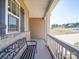 Covered porch with white railing and wrought iron bench at 721 Red Spruce Dr, York, SC 29745