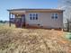 Tan vinyl siding home with screened porch and sloped yard at 721 Red Spruce Dr, York, SC 29745