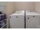 Bright laundry room complete with Maytag washer and dryer and extra shelving at 721 Red Spruce Dr, York, SC 29745