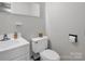 Simple half bathroom with white vanity and toilet at 7392 Reeps Grove Church Rd, Vale, NC 28168