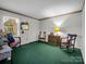 Bedroom with two armchairs and green carpet at 7392 Reeps Grove Church Rd, Vale, NC 28168