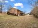 Brick home with attached garage and deck, nestled on a hillside at 7392 Reeps Grove Church Rd, Vale, NC 28168