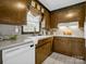 Kitchen with wood cabinets, white appliances, and a window at 7392 Reeps Grove Church Rd, Vale, NC 28168