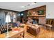 Cozy living room featuring a brick fireplace and hardwood floors at 7392 Reeps Grove Church Rd, Vale, NC 28168