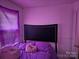 Bedroom with a bed, purple bedding, and window with blinds at 800 Thera Dr, Charlotte, NC 28206