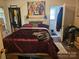 Main bedroom with a large bed and colorful art at 800 Thera Dr, Charlotte, NC 28206