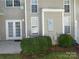 The home's backyard with french doors and a utility box with green bushes at 8620 Robinson Forest Dr, Charlotte, NC 28277