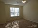 Bedroom with neutral carpet, ceiling fan, and window at 8620 Robinson Forest Dr, Charlotte, NC 28277