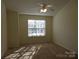 Cozy bedroom featuring neutral walls, plush carpeting, and a window with natural light at 8620 Robinson Forest Dr, Charlotte, NC 28277