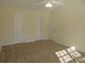 Bedroom featuring neutral walls, carpeting, and bright white doors with gold hardware at 8620 Robinson Forest Dr, Charlotte, NC 28277