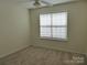 Neutral bedroom features carpet, ceiling fan, and a window with natural light at 8620 Robinson Forest Dr, Charlotte, NC 28277