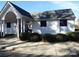 Clubhouse with white siding and gray shingles surrounded by manicured bushes at 8620 Robinson Forest Dr, Charlotte, NC 28277