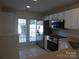 Bright kitchen featuring stainless steel appliances, white cabinets, and tiled floors at 8620 Robinson Forest Dr, Charlotte, NC 28277