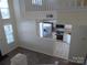 Kitchen view from staircase with stainless steel appliances at 8620 Robinson Forest Dr, Charlotte, NC 28277