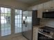 Bright kitchen featuring stainless steel refrigerator, range, microwave, and white cabinets at 8620 Robinson Forest Dr, Charlotte, NC 28277