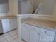 Kitchen featuring white cabinets and countertops, and tiled floors at 8620 Robinson Forest Dr, Charlotte, NC 28277