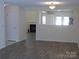 Spacious living room featuring hardwood floors with fireplace, a large opening into the kitchen and great light at 8620 Robinson Forest Dr, Charlotte, NC 28277