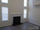 Bright living room with modern floors, fireplace, and large windows at 8620 Robinson Forest Dr, Charlotte, NC 28277