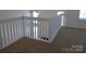 Loft with neutral carpet and white banister at 8620 Robinson Forest Dr, Charlotte, NC 28277