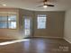 Living room with hardwood floors, ceiling fan and backyard access at 9446 Avery Lilac Ln, Fort Mill, SC 29707